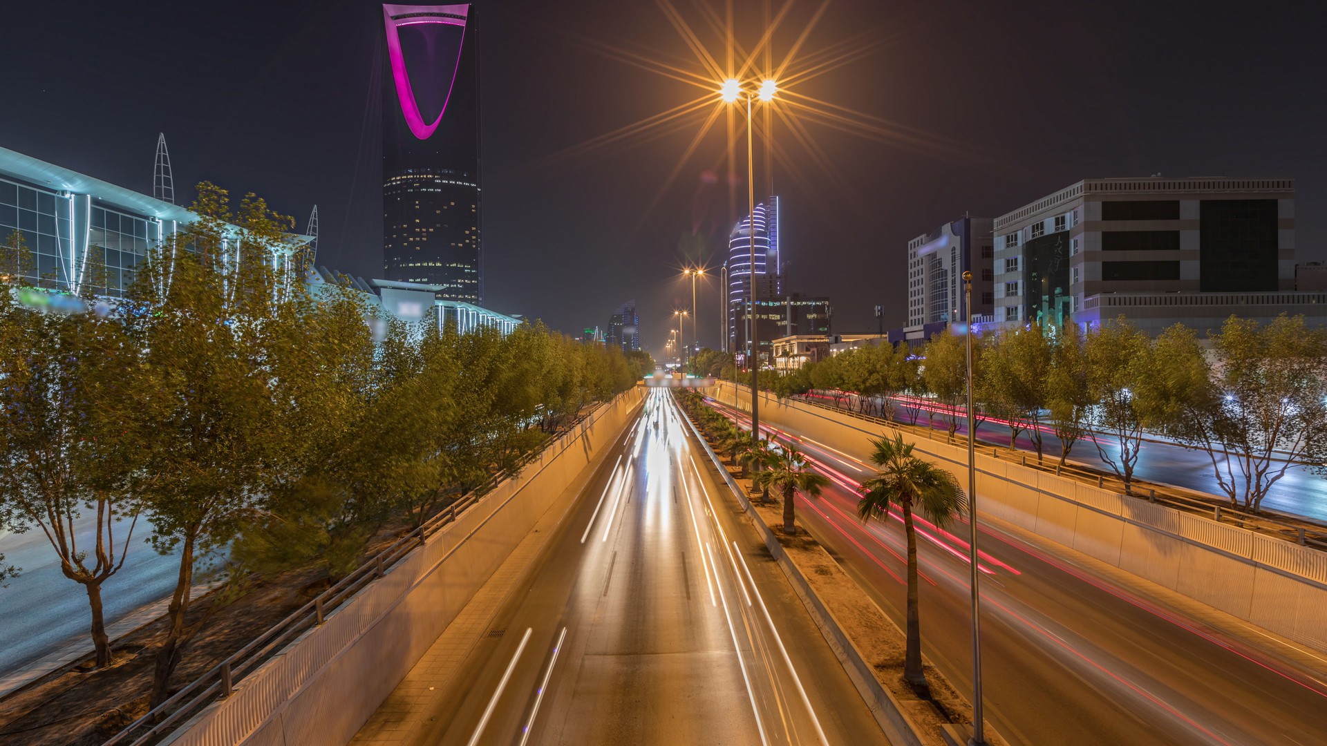 Panoramic aerial night timelapse of Riyadh featuring highway traffic, Kingdom Tower. Saudi Arabia